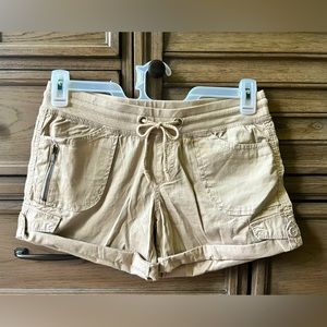 These shorts are a size medium, and a tan color.